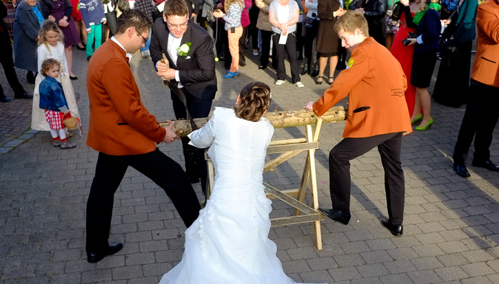 Bride and Groom Sawing a Log